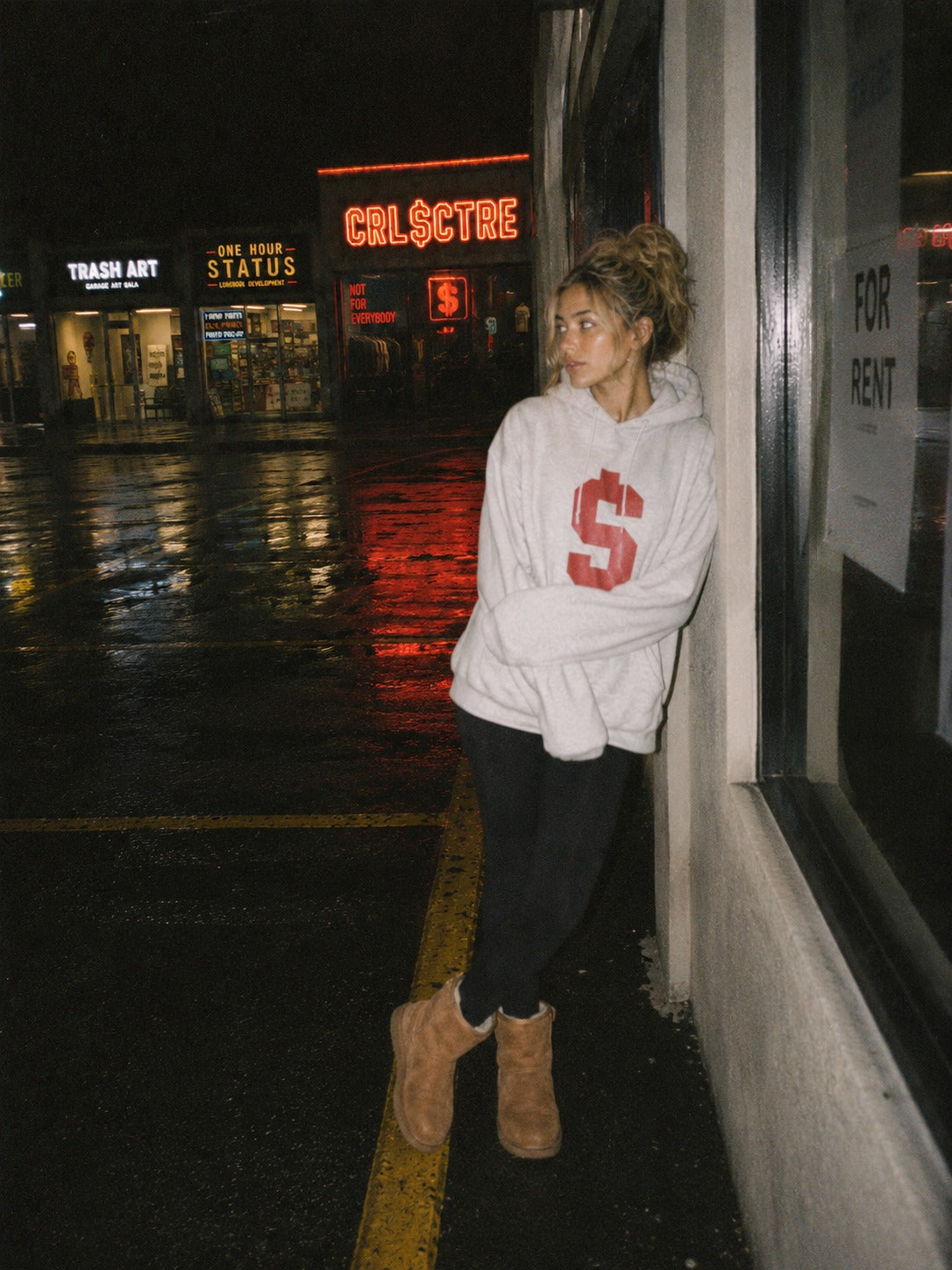 CRL$CTRE model in gray hoodie outside strip mall