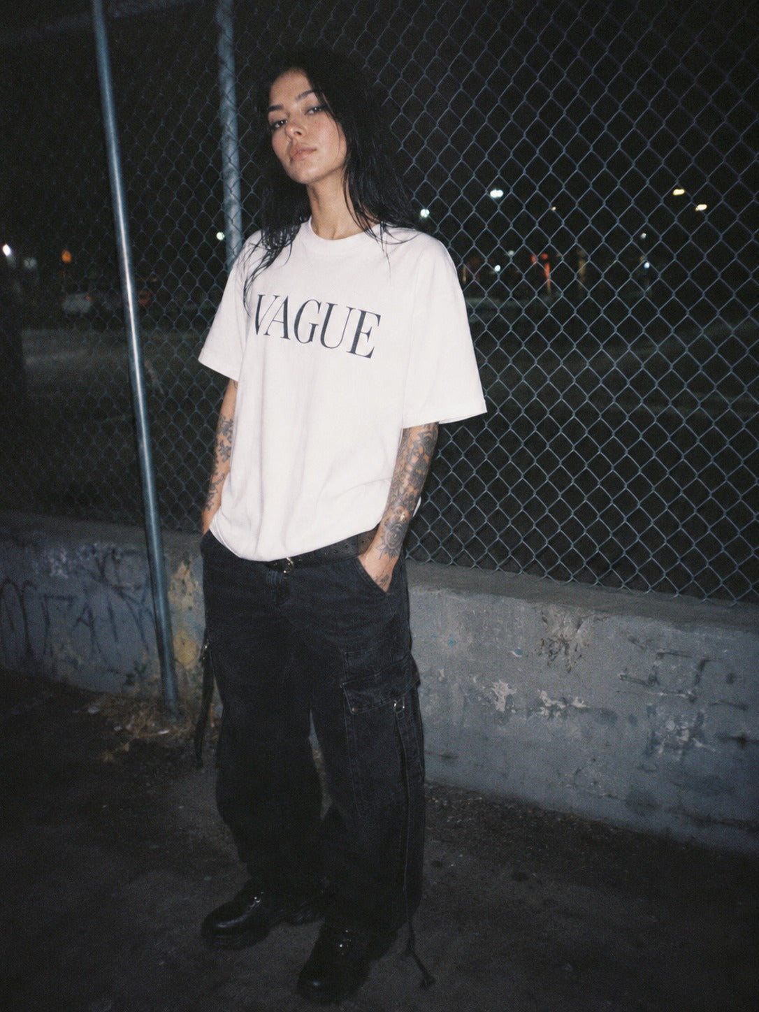 CRL$CTRE model wearing Vague shirt by a fence
